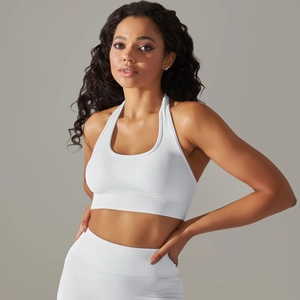 Detail showing white seamless knitted yoga set with wide ribbed waistband and crop halter top