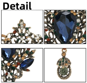 Macro view of vintage bronze water drop brooch with blue gem and colorful rhinestones