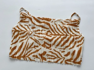 Detailed close-up of brown and white zebra print pleated camisole with elastic texture