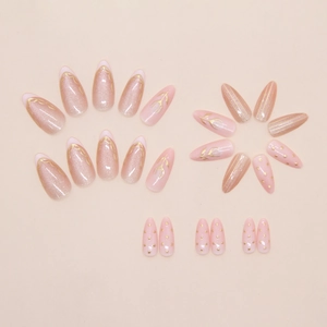 Detail of almond-shaped press-on nails with cat-eye effect and gold floral lace designs