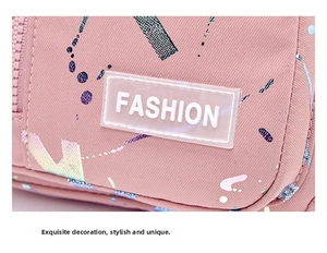 Close-up of pink canvas fabric with colorful graffiti and a silicone FASHION label