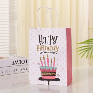 Pink polka dot paper gift bag with happy birthday cake design and white rope handles