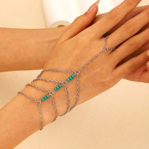 Detail of layered silver chain slave bracelet with turquoise beads on model's hand