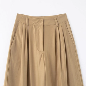 Khaki high-waisted wide-leg trousers featuring pleated waist detail and premium fabric texture