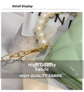 Detail of light green quilted jelly bag with large pearl handle and gold chain strap
