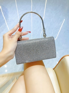 Detail of silver rhinestone handbag with metallic round handle for elegant evening parties
