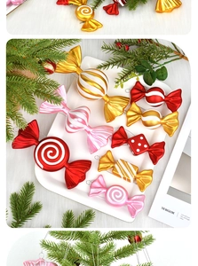 Assorted colorful PVC candy Christmas ornaments on a white tray with pine needles