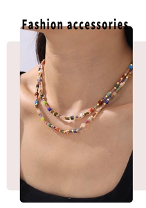 Detail of bohemian layered necklace featuring multi-colored square beads and gold accents