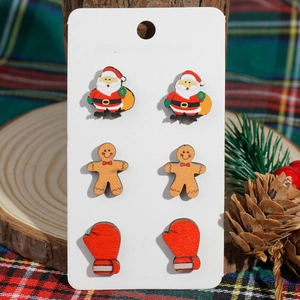 Detailed view of wooden Christmas earrings featuring Santa Claus and Gingerbread Man