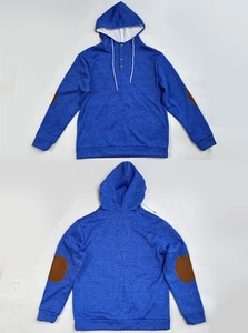 Detail of hoodie with three wooden buttons on collar and brown elbow patches