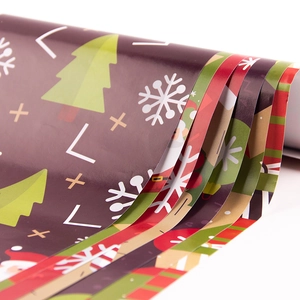 Christmas gift wrapping paper rolls with festive patterns like trees and snowflakes