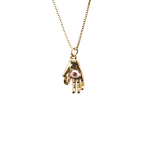 Golden Hamsa hand pendant necklace with evil eye detail on a polished box chain
