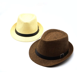 Detail of woven straw fedora hats in beige and dark brown with black buckle bands