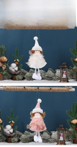 Detail of plush Christmas angel ornaments in white and pink with glittering wings