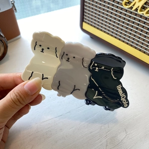 Cute acetate hair claw clip featuring three layered poodles in white, gray and black