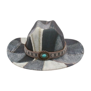 Detail of western cowboy hat featuring patchwork denim and ethnic band with turquoise stone
