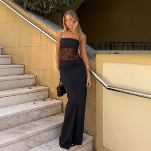 Detail of floral lace patchwork and sheer waist design on a black floor-length maxi dress