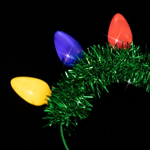 Detail of Christmas headband with tinsel and glowing red, blue and yellow bulb ornaments