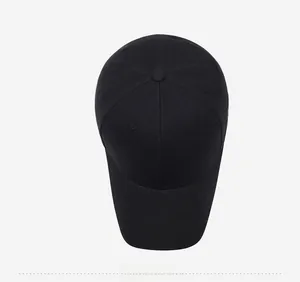 Top-down view of a black six-panel baseball cap showing stitching and crown button detail