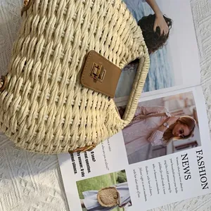 Chic beige woven straw handbag with brown leather buckle and golden lock for beach vacations
