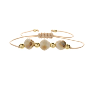 Detailed view of handmade woven cord bracelet with shell beads and golden accents