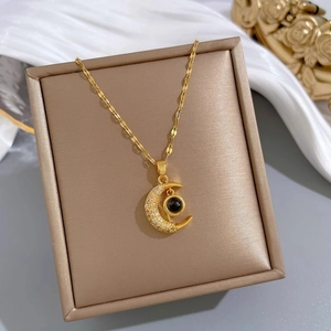 Luxurious gold crescent moon pendant necklace with micro-pave stones on elegant silk