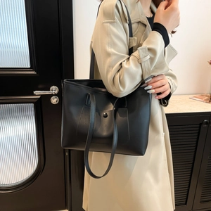 Minimalist large capacity black leather tote bag for women with front pocket and shoulder straps