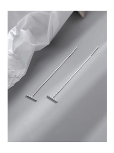 Detail of minimalist S999 silver T-bar threader earrings with a long hanging design