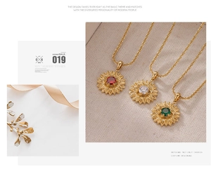 Detailed close-up of sunflower pendant necklaces in red, green and clear gemstones