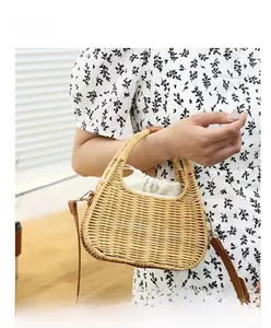 Close-up of handmade straw handbag featuring inner drawstring pouch and leather strap