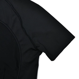 Close-up of black short sleeve jumpsuit showing premium fabric texture and seam stitching