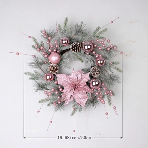 Pink Christmas wreath with ornaments and frosted pine cones on wall, 50cm diameter