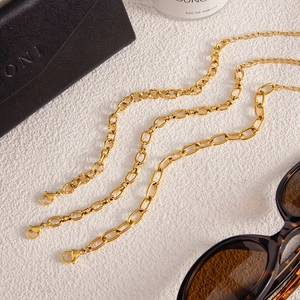 Detailed close-up of 18k gold-plated titanium steel chain with lobster clasp and oval links