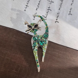 Cat brooch pin with green rhinestones in an antique silver finish for women