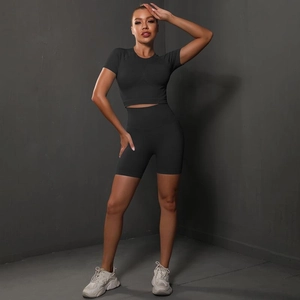Detail of a black high-waist seamless cycling shorts and cropped yoga top fitness set