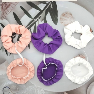 Detail of 6-piece elastic hair scrunchie cup cover set in pink, purple, and white fabric