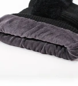 Detail of the soft gray fleece lining and thick black knit texture of the winter beanie