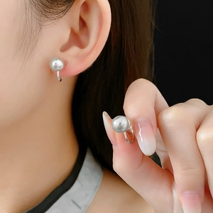Detailed view of elegant grey pearl ear cuff with polished silver-tone metal clip