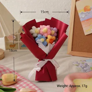 Handmade knitted mini flower bouquet with colorful crochet blossoms in red gift wrapping