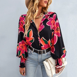 Dettaglio camicia floreale con scollo a V, maniche a lanterna e vivaci motivi a fiori