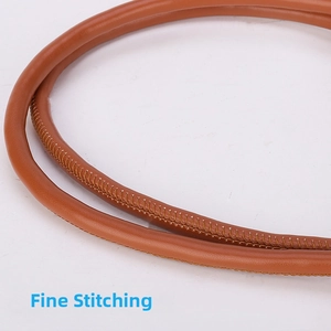 Macro shot of fine stitching and premium leather texture on a brown adjustable bag strap