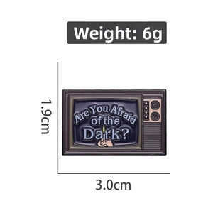 Detail view of retro TV enamel pin showing 3.0cm x 1.9cm size and 6g weight specs