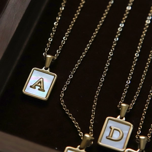18K gold plated stainless steel letter necklace featuring white shell inlay pendants