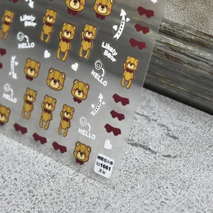 Detailed view of thin cartoon brown bear nail stickers with bows on clear film