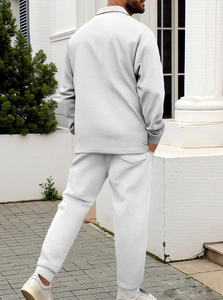 Detail of light gray knitted tracksuit featuring premium waffle texture and slim fit design
