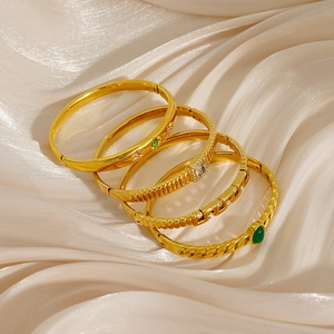 Five-piece gold-plated titanium steel bracelet set with crystals on champagne silk background