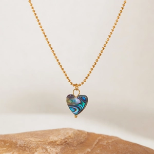 Golden bead chain necklace with heart pendant featuring colorful abalone shell inlay