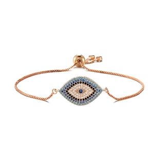 Detail of rose gold evil eye bracelet with blue and white cubic zirconia settings