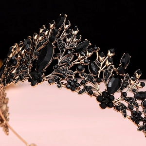 Close-up of black gemstones and vintage gold floral details on baroque bridal crown