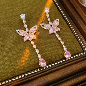 Detail of pink butterfly drop earrings with cubic zirconia and pear-shaped gemstones